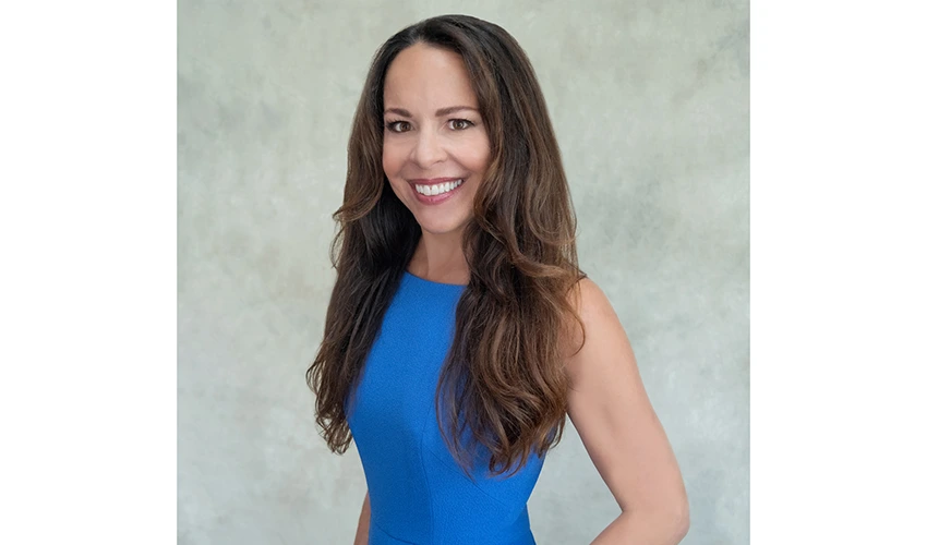photo of a woman in a blue dress looking at the camera